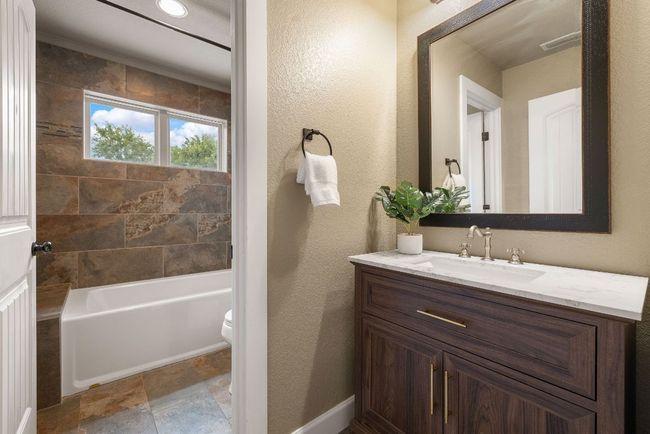 Upstairs full bath with separate vanity and tub/shower combo. | Image 25
