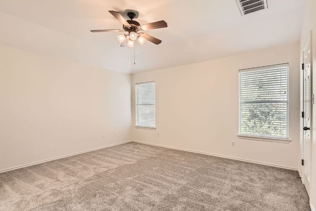 Primary bedroom upstairs featuring carpet and ceiling fan | Image 19