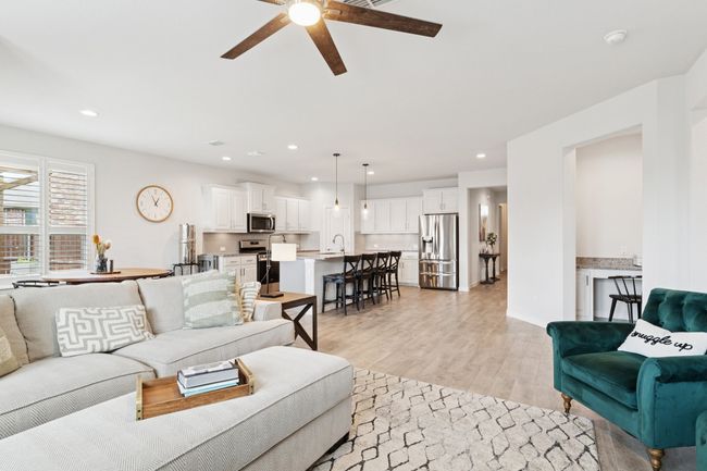 Living room featuring ceiling fan, light wood-style flooring, and recessed lighting | Image 7