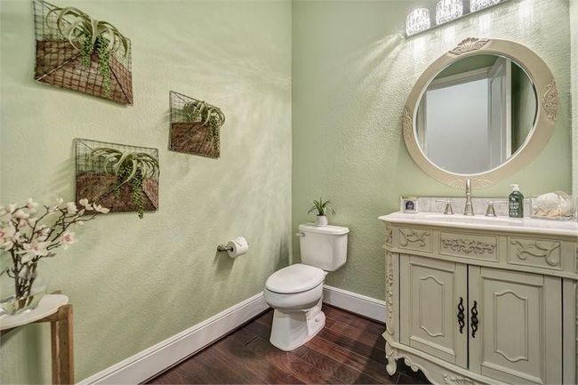 Half bath with thoughtful design is conveniently located by the living room. | Image 21
