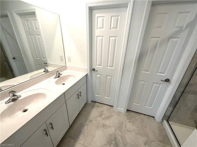 Bathroom featuring double vanity and a stall shower | Image 15