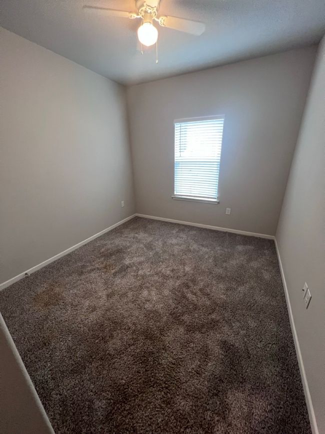 Carpeted spare room with a ceiling fan and baseboards | Image 10