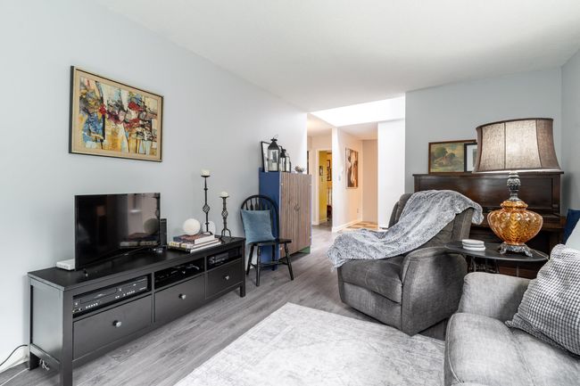 Living area with light wood-style floors | Image 11