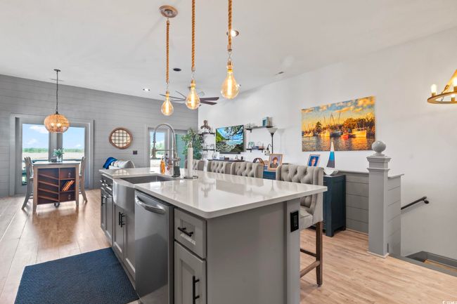 Kitchen with stainless steel dishwasher, a healthy amount of sunlight, and light wood-style flooring | Image 9