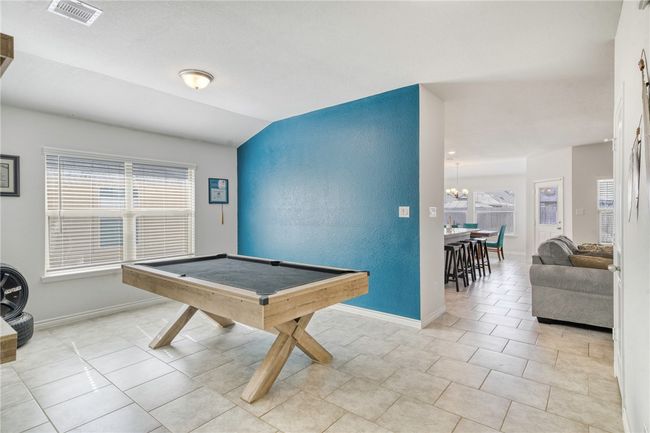 Rec room featuring lofted ceiling, billiards, a chandelier, and light tile patterned flooring | Image 7