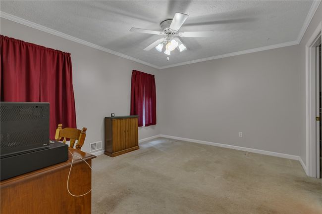 A view of the master bedroom from the entry door. Full bath and closet to the right of the room. | Image 11