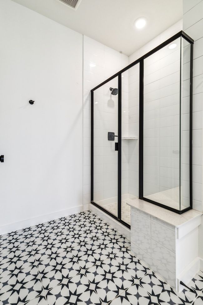 Bathroom with a shower stall, tile patterned floors, and baseboards | Image 21