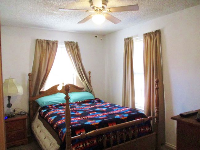 Bedroom featuring a textured ceiling and a ceiling fan | Image 15