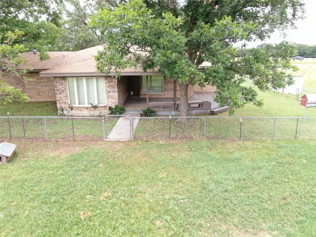View of front of home featuring brick siding and roof with shingles | Image 24