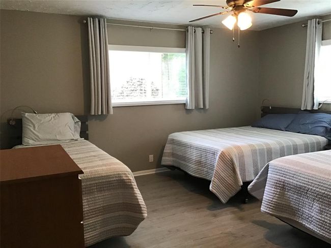 Generous size bedroom has ample room for multiple beds. | Image 35