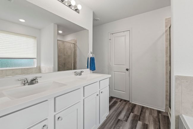 The primary bath features dual vanities, walk-in closet and luxury vinyl plank flooring... | Image 19
