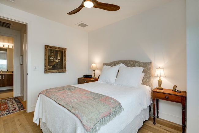Bedroom with wood finished floors and a ceiling fan | Image 12