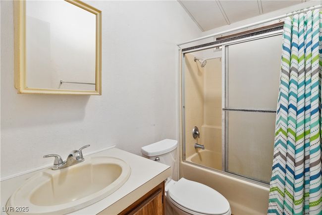 Bathroom featuring toilet, shower / bath combination with glass door, and​​‌​​​​‌​​‌‌​‌‌​​​‌‌​​‌‌​‌​​​​​‌ vanity | Image 18