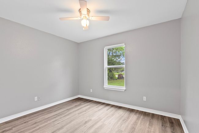 Empty room featuring wood finished floors and ceiling fan | Image 21