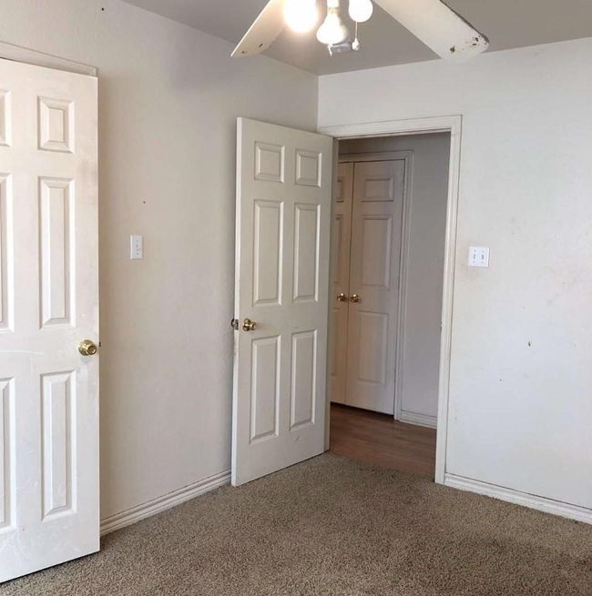 Unfurnished bedroom with carpet, a ceiling fan, and baseboards | Image 8