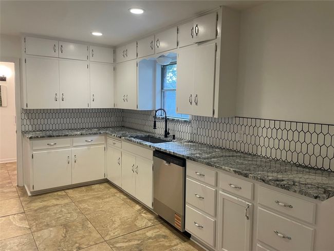 Kitchen with dishwasher, backsplash, white cabinetry, and recessed lighting | Image 5