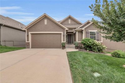 View of front of property featuring a front yard and a garage | Image 2