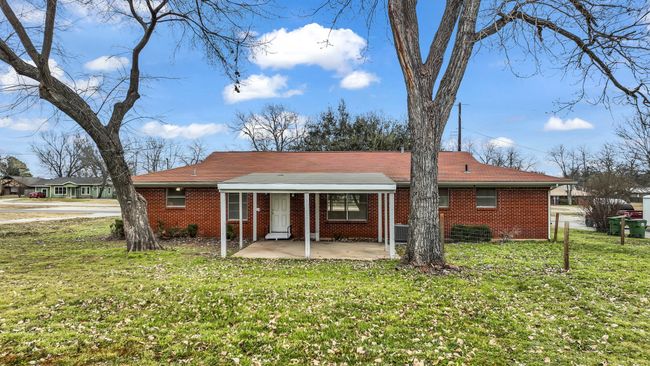 Rear view of house featuring a partially fenced yard and patio area | Image 24