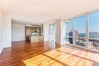 Unfurnished living room with hardwood / wood-style flooring and floor to ceiling windows | Image 2