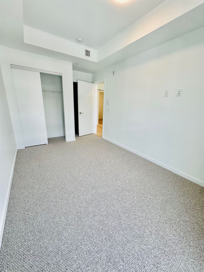 Unfurnished bedroom featuring light colored carpet, a closet, visible vents, and baseboards | Image 10