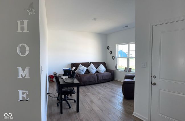 living room featuring baseboards, visible vents, and light wood-type flooring | Image 5