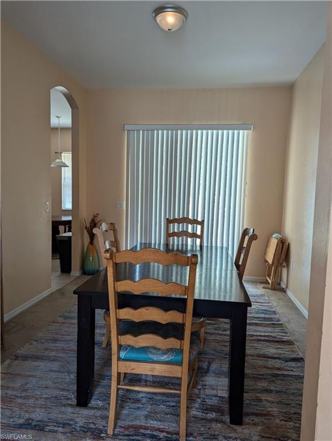 Dining space featuring arched walkways, healthy amount of natural light, carpet floors, and baseboards | Image 15