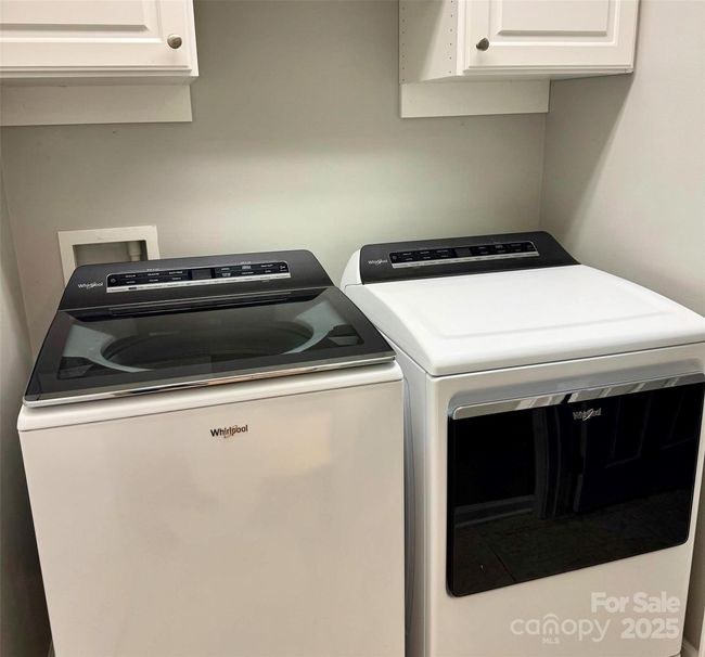 Main-level laundry, washer and dryer convey | Image 17