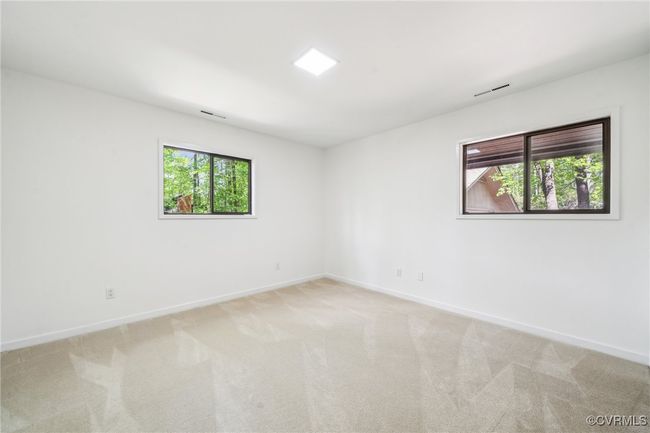 Carpeted empty room with visible vents, baseboards, and a healthy amount of sunlight | Image 38