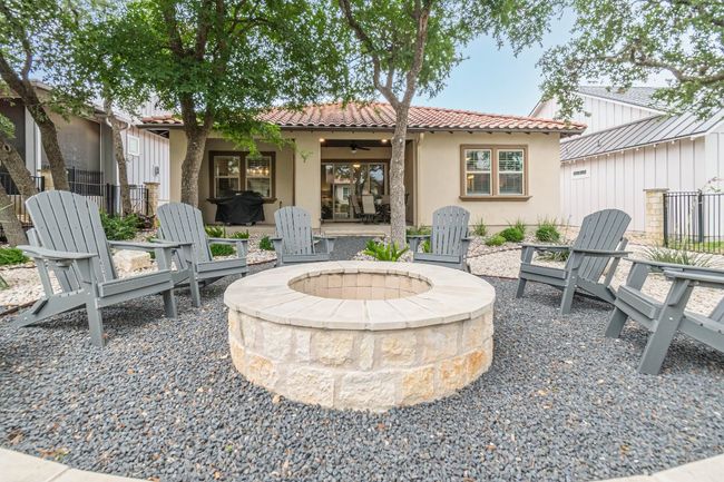 View of patio with a fire pit and a ceiling fan | Image 36