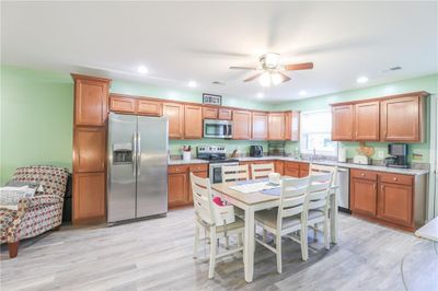 Kitchen with appliances with stainless steel finishes, light wood-type flooring, and ceiling fan | Image 3