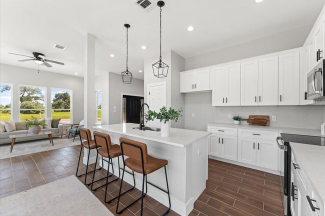 Modern kitchen with center island, open to the dining and living room. | Image 10