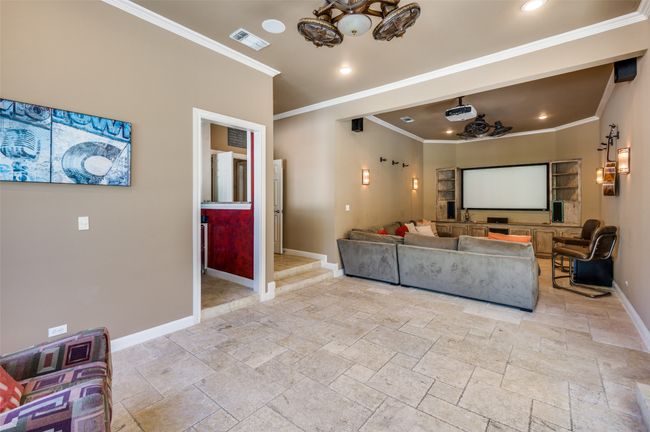 Living area featuring ornamental molding, baseboards, stone tile floors, and recessed lighting | Image 28