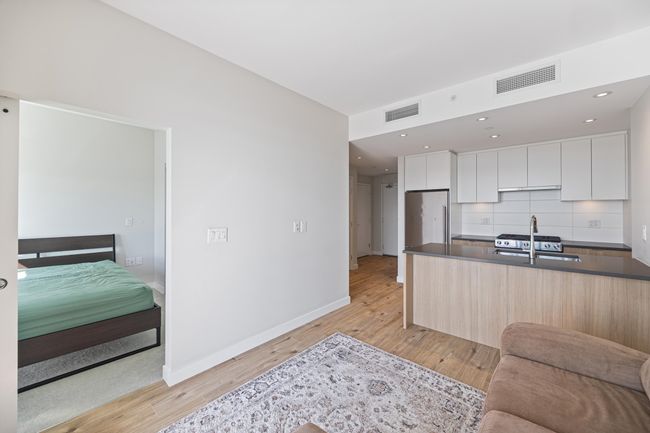 Kitchen with visible vents, modern cabinets, and a sink | Image 11