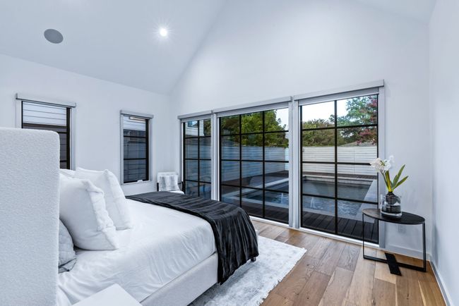 Bedroom with high vaulted ceiling, multiple windows, wood-type flooring, and recessed lighting | Image 18