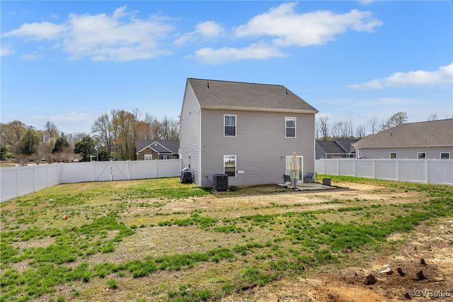 Back of property featuring a lawn, central air condition unit, and a fenced backyard | Image 22
