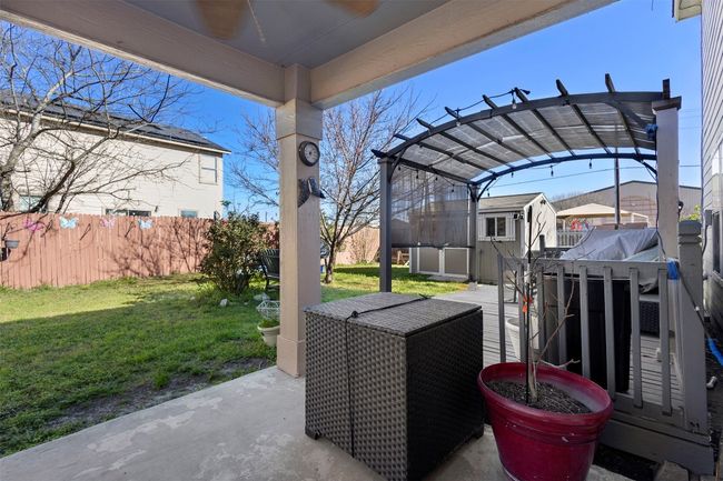 View of patio / terrace with a pergola, fence, a shed, and an outdoor structure | Image 30