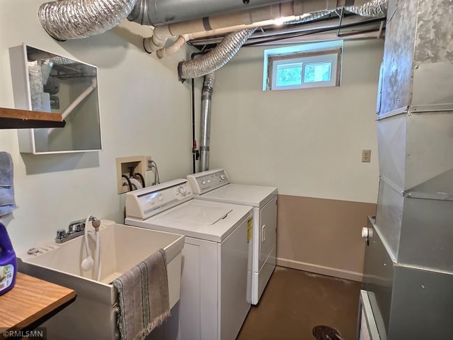 The laundry room is located in the lower level and offers a nice amount of space and lighting. | Image 18