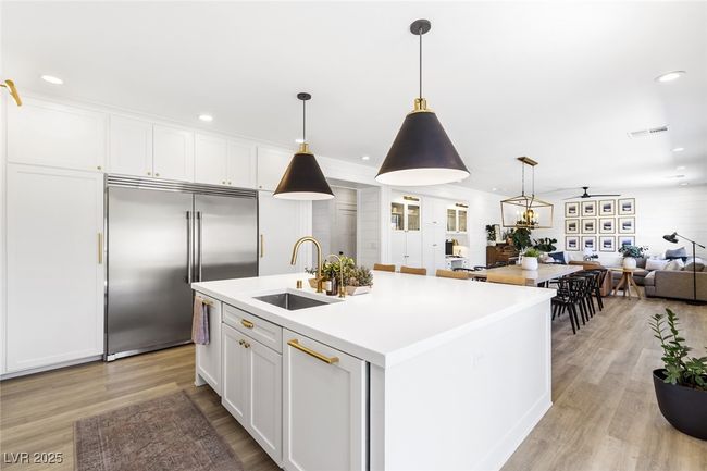 Kitchen with visible vents, a sink, white cabinetry, and built in refrigerator | Image 17