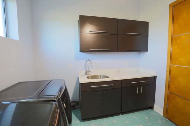 Washroom featuring cabinets, sink, and washer and dryer | Image 5