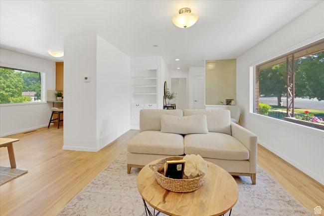 Living area with light wood-style floors and baseboards | Image 4