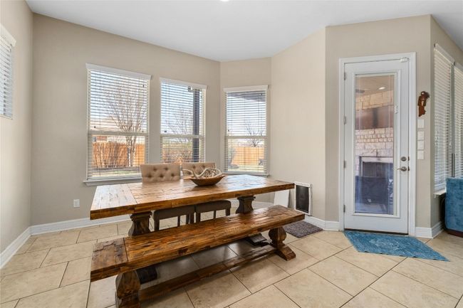 Dining room with baseboards and light tile patterned floors | Image 11