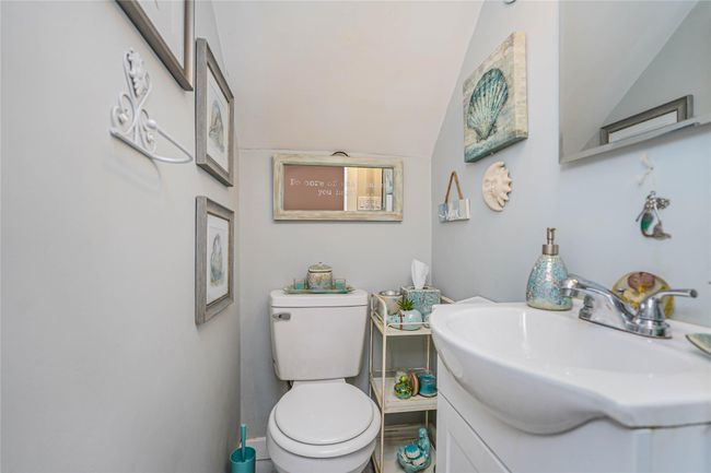 Half bath with vaulted ceiling, vanity, and toilet | Image 4