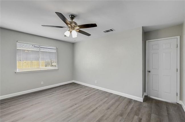 Empty room featuring wood finished floors, baseboards, and a ceiling fan | Image 17