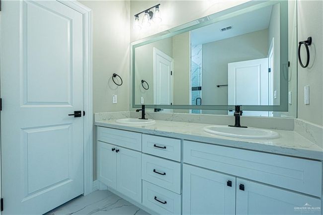Full bathroom with marble finish floor, visible vents, a sink, and double vanity | Image 7