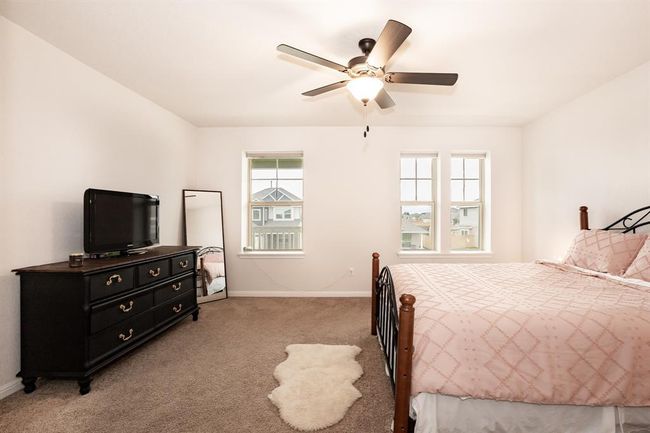 Bedroom with light colored carpet and ceiling fan | Image 22