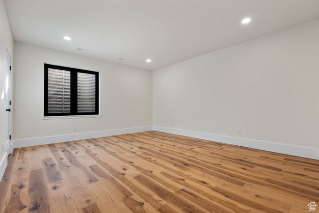 Spare room featuring light wood-style floors and recessed lighting | Image 65