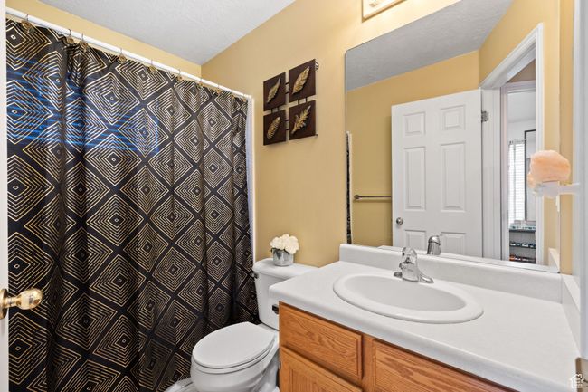 Bathroom featuring vanity, toilet, and a textured ceiling | Image 24