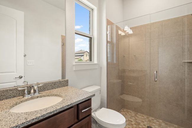 Full bathroom with a shower stall, toilet, and vanity | Image 20