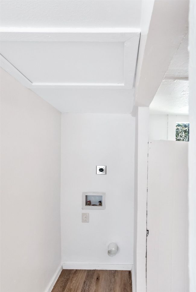 Washroom with hookup for an electric dryer, wood finished floors, and hookup for a washing machine | Image 34