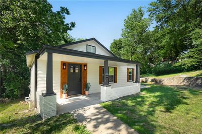 View of front facade featuring a porch and a front lawn | Image 1